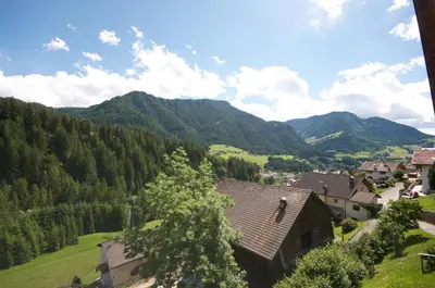 a view of a village with mountains in the background at Apartments Dolina in Ortisei