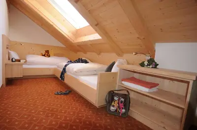 a room with two beds in a cabin at Apartments Dolina in Ortisei