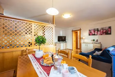 a living room with a table with food on it at Ciasa de Vich in Vigo di Fassa