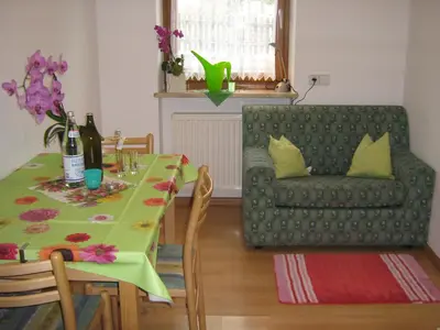 a living room with a table and a couch at Pitterle Hof in Meltina