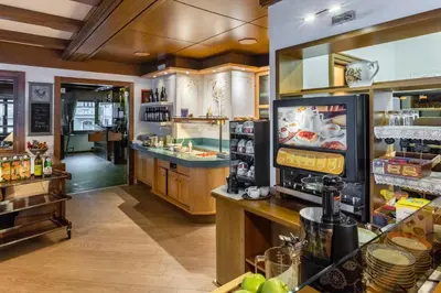 a restaurant with a food counter and a counter at Albergo Contrin in Campitello