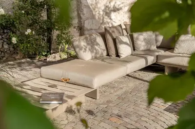 a couch sitting on a patio with a table at Ansitz Romani in Termeno
