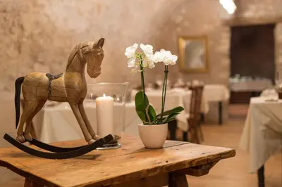 a wooden horse statue on a wooden table with a candle at Ansitz Romani in Termeno