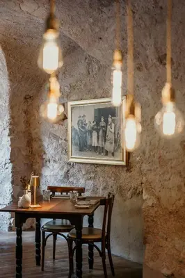 a dining room with a table and a picture on the wall at Ansitz Romani in Termeno