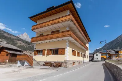 a house in the middle of a street at Casa Carnevali in Pozza di Fassa