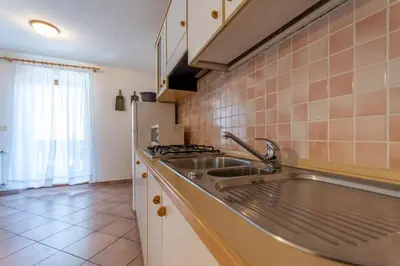 a kitchen with a sink and a stove at Casa Fanton in Pozza di Fassa