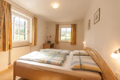 a bedroom with a bed with two pillows on it at Hofer Hof in Castelrotto