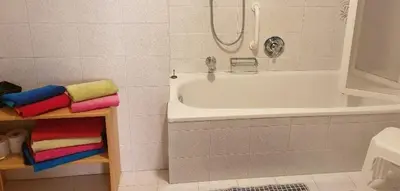 a bathroom with a white tub and a sink at Hofer Hof in Castelrotto