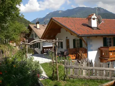 a white house with a wooden fence in front of it at Hofer Hof in Castelrotto