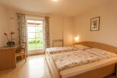 a bedroom with a bed and a window at Hofer Hof in Castelrotto