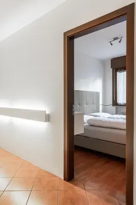 a bedroom with a bed and a large mirror at Apartment Goethe 1 in Bolzano