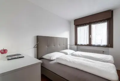 a bedroom with a large bed with a window at Apartment Goethe 1 in Bolzano