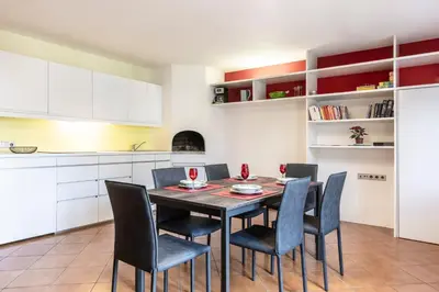 a kitchen with a dining room table and chairs at Apartment Goethe 1 in Bolzano
