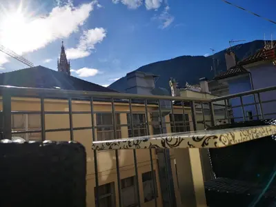 a balcony of a building with mountains in the background at Apartment Goethe 1 in Bolzano