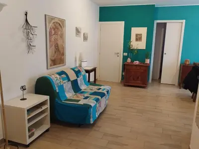 a living room with a couch and a table at Casa Turchese in Merano