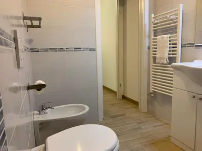 a bathroom with a toilet and a sink at Casa Turchese in Merano