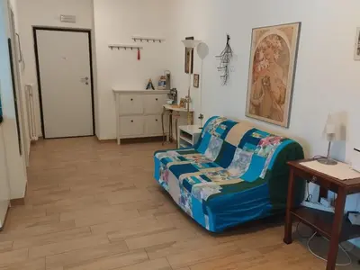 a living room with a couch and a table at Casa Turchese in Merano