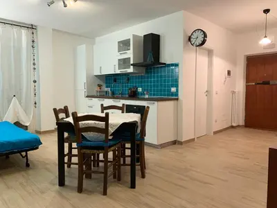 a kitchen and dining room with a table and chairs at Casa Turchese in Merano