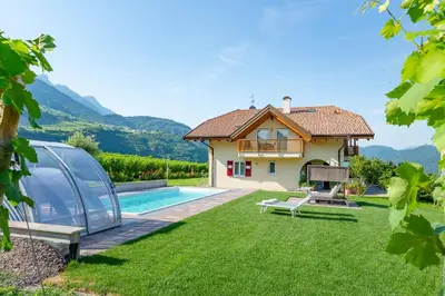 a villa with a swimming pool and a house at St. Urbanhof in Termeno
