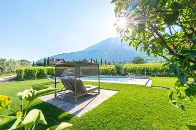 a garden with a swing and a swimming pool at St. Urbanhof in Termeno