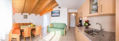 a kitchen with a table and a dining room at St. Urbanhof in Termeno