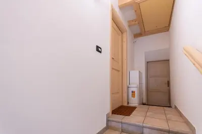 a hallway with a door leading to a garage at Casa Sartori in Pozza di Fassa