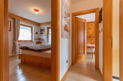 a small bedroom with a bed in a room at Casa Sartori in Pozza di Fassa