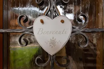 a heart sign on a door with the word beautiful at Casa De La Veisc in Pozza di Fassa