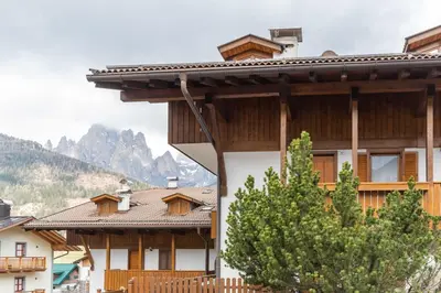 a group of buildings with mountains in the background at Casa Fave' in Pozza di Fassa