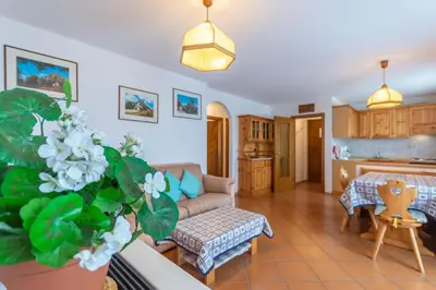 a living room with a couch and a table at Casa Fave' in Pozza di Fassa