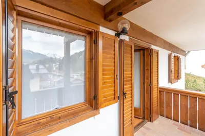 a room with a window and a view of a mountain at Casa Fave' in Pozza di Fassa