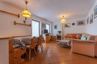 a living room with a couch and a table at Casa Fave' in Pozza di Fassa