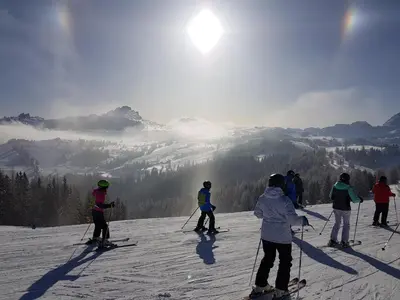 a group of people on skis on a ski slope at Chalet alla Cascata in Badia