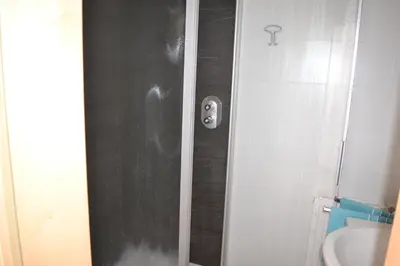 a shower with a black door in a bathroom at Gruberhof in Rodengo