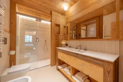 a bathroom with a sink and a toilet and a shower at Villa Oretta in Cortina dʼAmpezzo