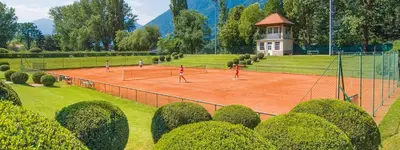 a group of people playing tennis on a tennis court at Penthouse & Garden - luxury apartment in Postal