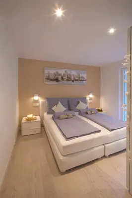 a bedroom with a large white bed with blue sheets at Penthouse & Garden - luxury apartment in Postal