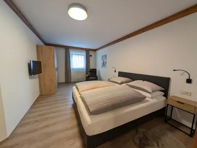 a bedroom with a large bed in a room at Sonnenresidenz Kastelruth in Castelrotto