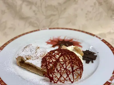 a white plate with two pieces of dessert on it at Hotel Waldheim in Sarnonico