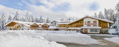 a lodge in the snow with a lot of snow at Hotel Waldheim in Sarnonico