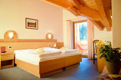 a bedroom with a large bed in a room at Hotel Waldheim in Sarnonico