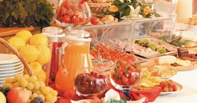 a buffet of food with fruits and vegetables on a table at Hotel Garni Hubertus in Tirolo