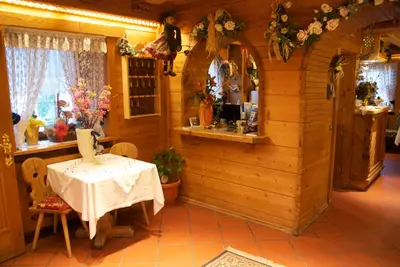 a dining room with a table in a house at Albergo Genziana in San Vigilio Di Marebbe