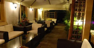 a living room with two leather chairs and a table at Albergo Genziana in San Vigilio Di Marebbe