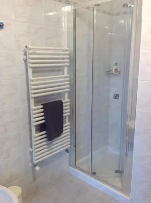 a bathroom with a shower with a glass door at VILLA ROOMS in Laives