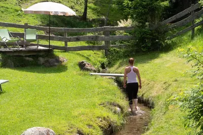a woman walking down a path in a field at Wieshof in Laion