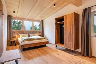 a bedroom with a bed and a large window at Wieshof in Laion