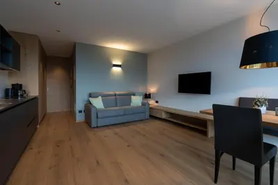 a living room with a couch and a television at Feldhof Vilpian- Urlaub auf dem Bauernhof in Vilpiano
