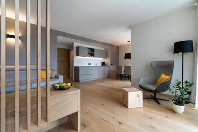 a bedroom with a bed and a chair in a room at Feldhof Vilpian- Urlaub auf dem Bauernhof in Vilpiano