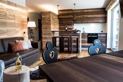 a living room with a couch and a table at Garni Residence Soraiser in Selva di Val Gardena